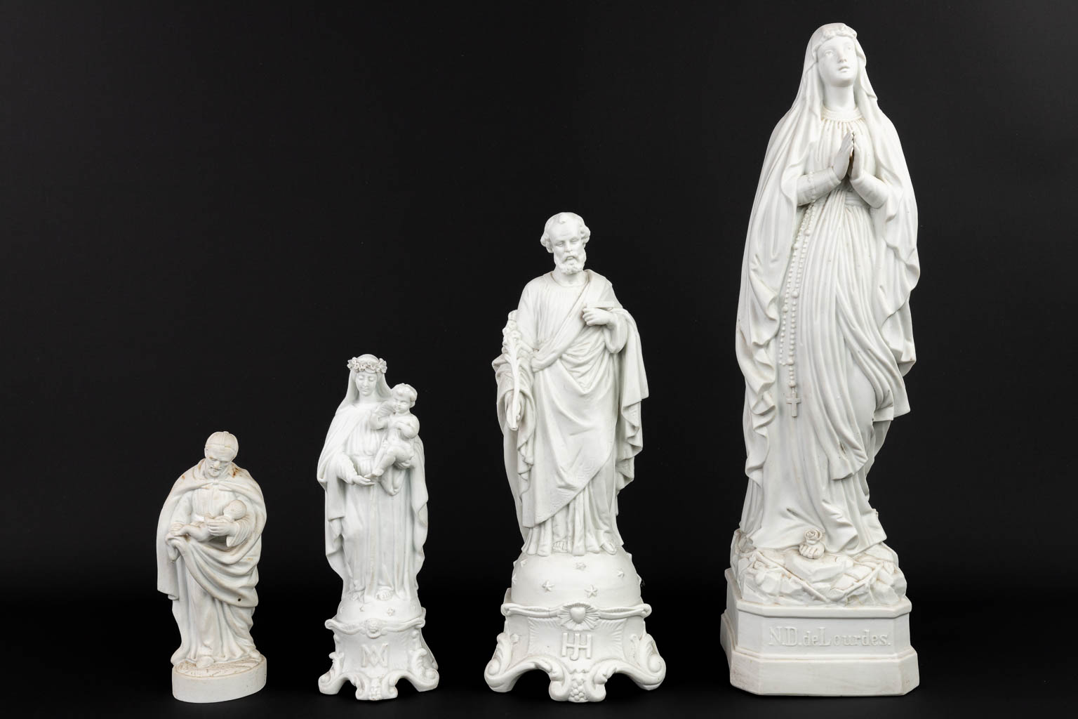 A collection of 4 biscuit porcelain statues of holy figurines. (H:52,5cm)