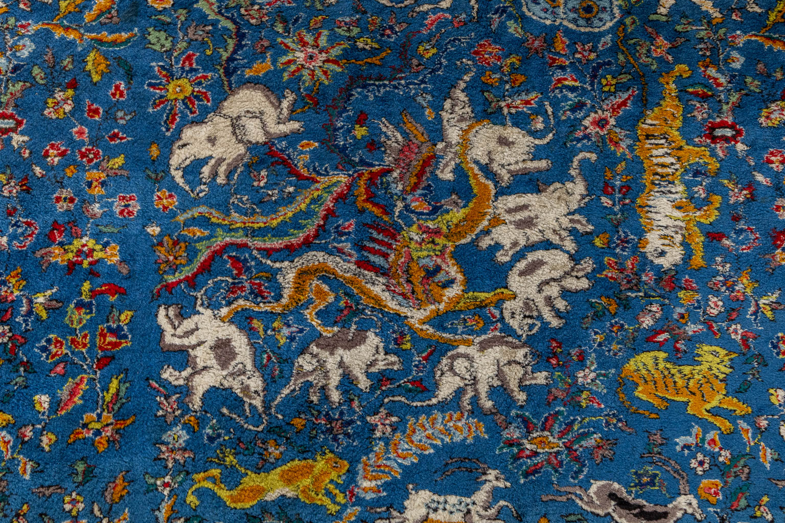 An Oriental hand-made carpet with figurative decor, Tabriz. (L:340 x W:243 cm)