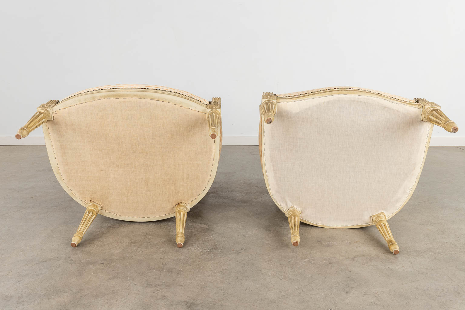 A pair of armchairs, sculptured wood with fabric in Louis XVI style. (D:64 x W:66 x H:92 cm)