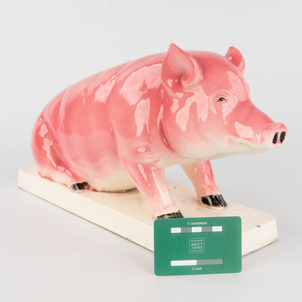 A pig, glazed faience. Circa 1900. (L: 13 x W: 40 x H: 22 cm)