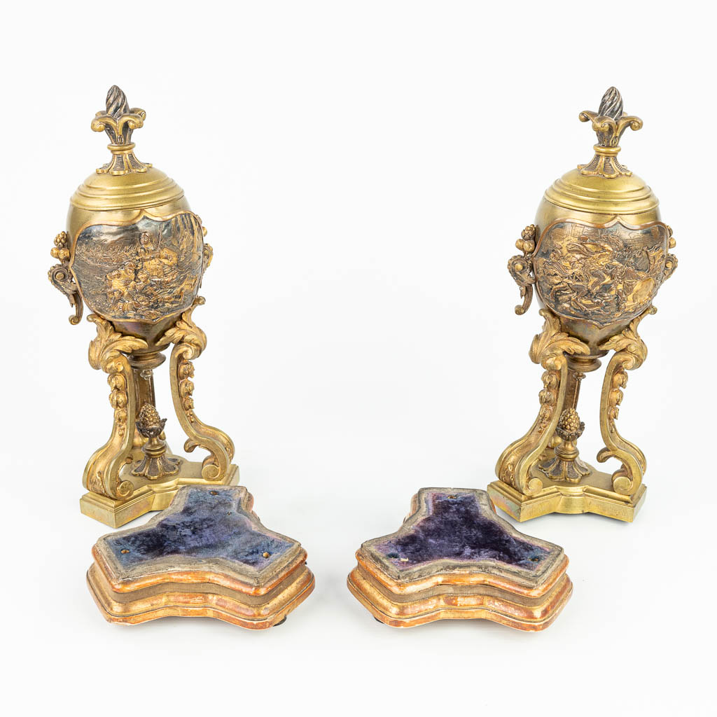 A pair of bronze cassolettes with images of knights in battle signed William McLaren. (H:36cm)