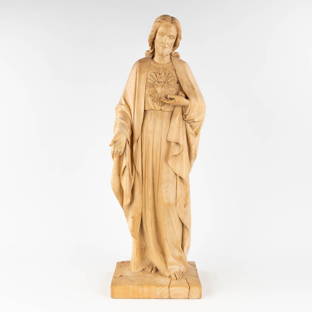 A wood-sculptured figurine of Jesus Christ with a Sacred Heart. The first half of the 20th century. (L: 22 x W: 25 x H: 77 cm)