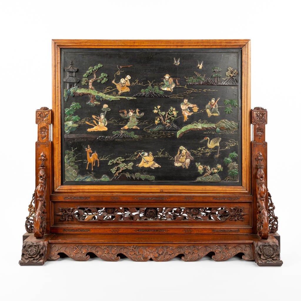 Lot 078 A Chinese sculptured table screen with images of the 8 immortals, cranes, deer and pine trees. (H:80cm)