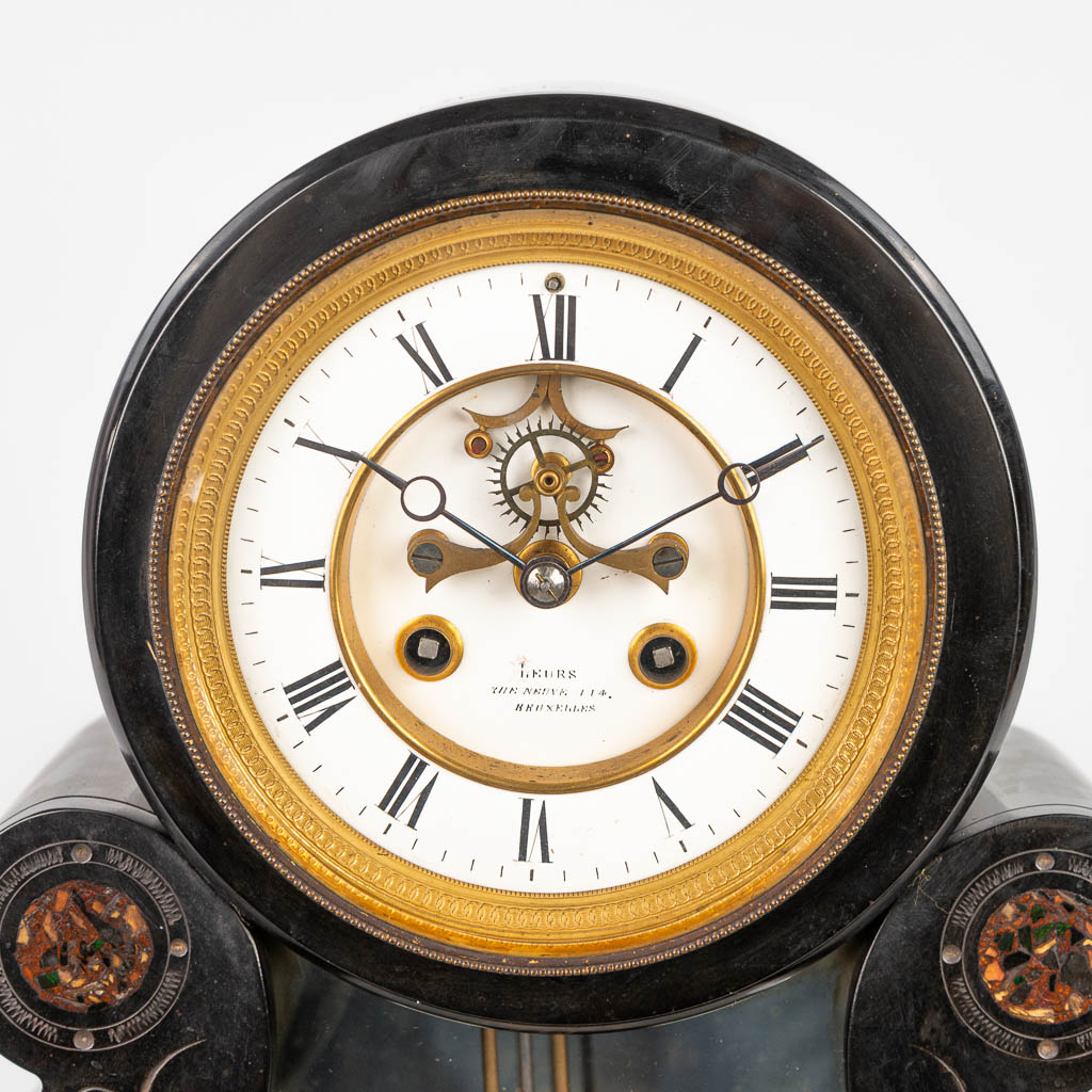 A table clock made of black marble with red marble inlay and a mercury style pendulum. (H:47cm)