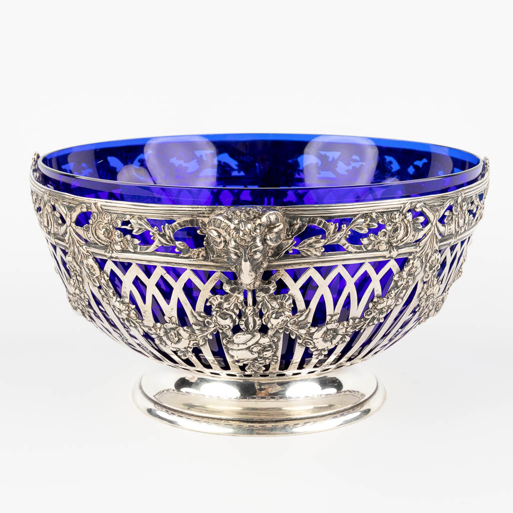 A bowl, silver and blue glass, decor of ram's heads and garlands. Germany. 684g. (D:25 x W:27 x H:13 cm)