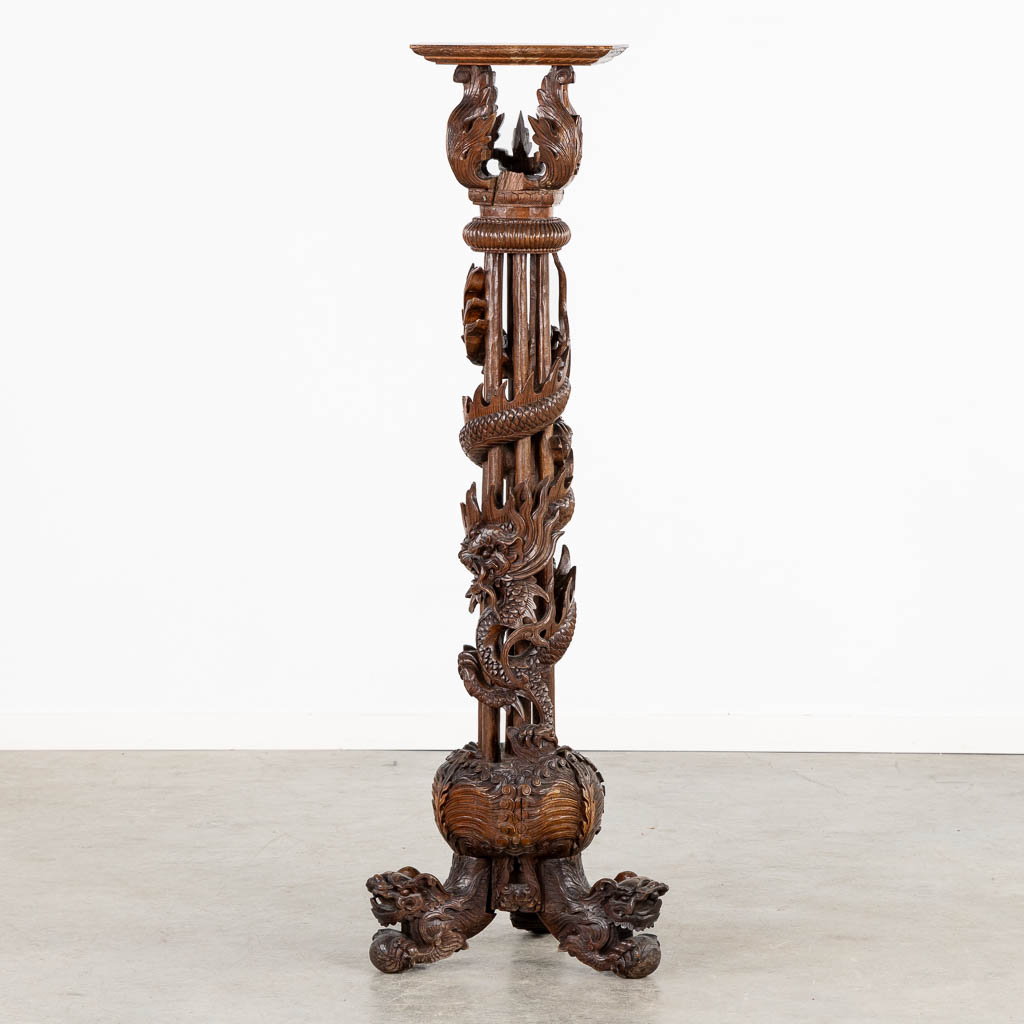Lot 036 A Oriental hardwood pedestal with a sculptured dragon. (W:42 x H:125 cm)