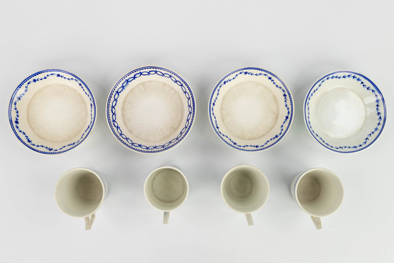 A collection of 3 plates, 4 cups and saucers made in Doornik. The first half of the 19th century. 