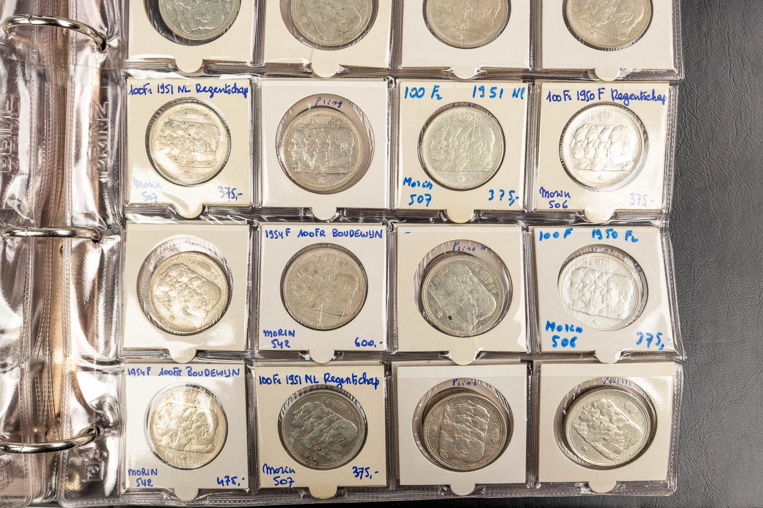 A large collection of coins, of which most are silver and 2 are gold. 