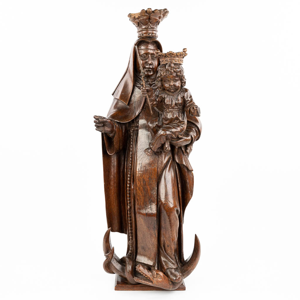 A large statue of Madonna with a child, trampling the serpent on a crescent, made of sculptured oak. (H:83cm)