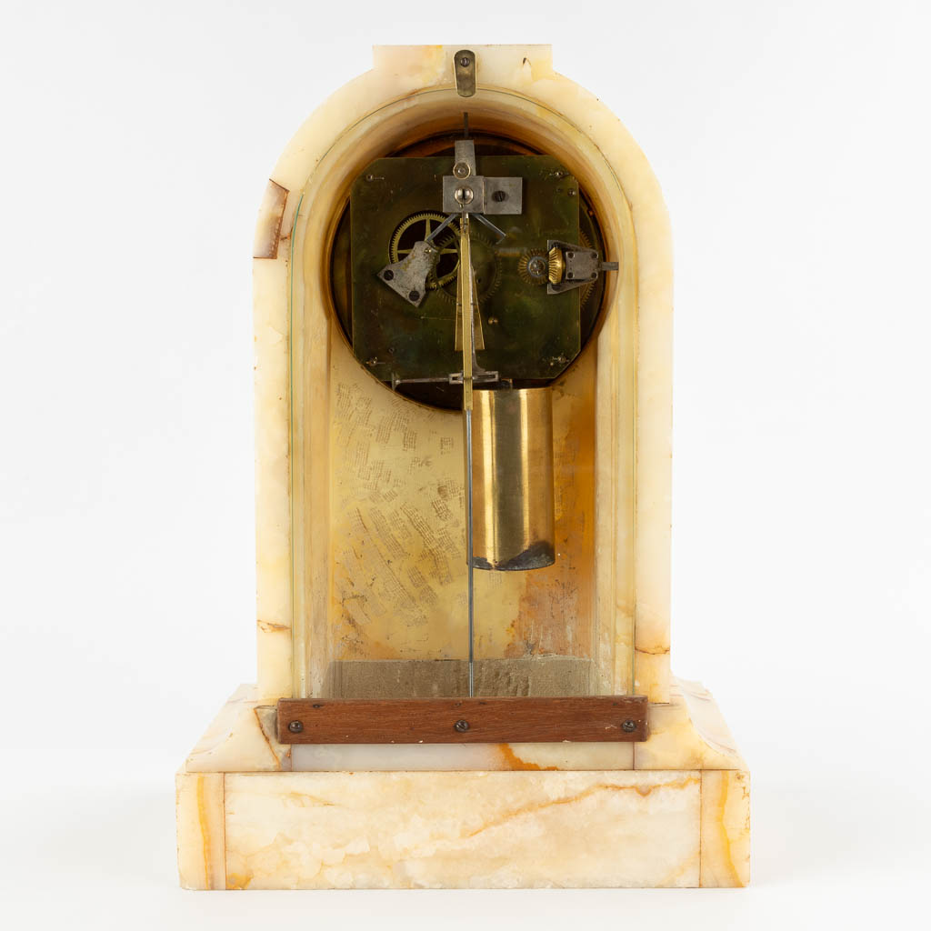 A mantle clock with a wight, 