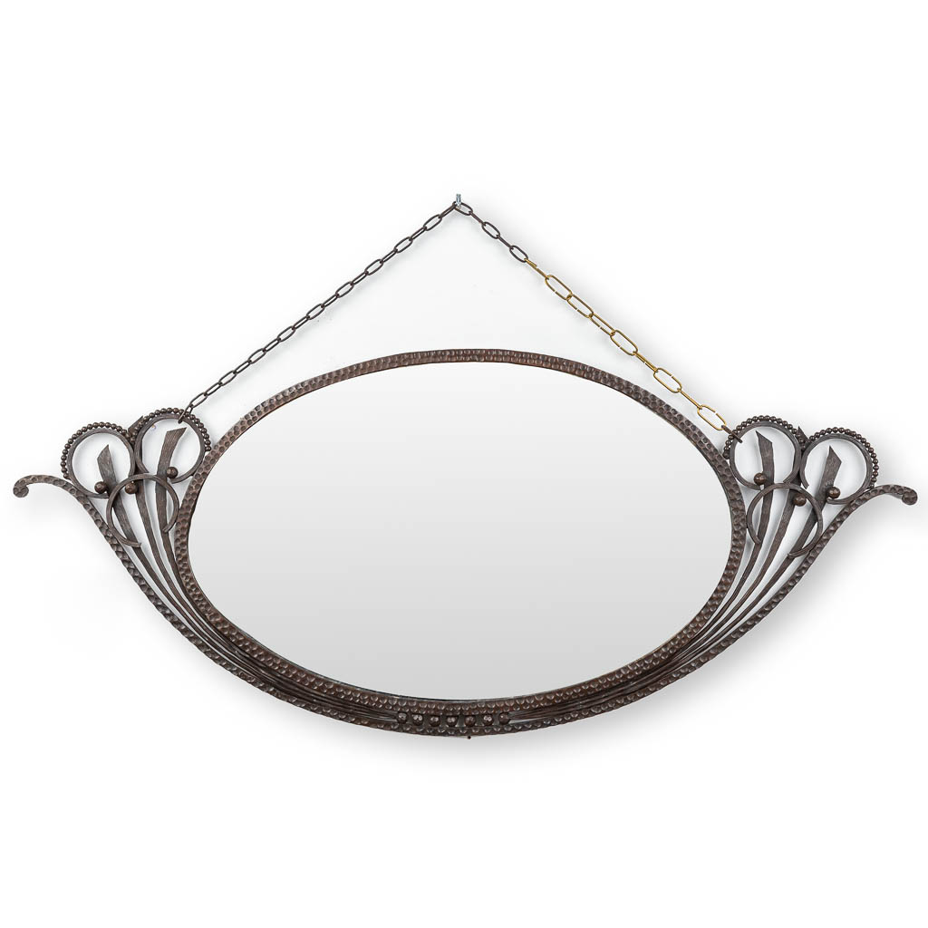 An oval mirror with a wrought iron frame, circa 1920.  (W:115 x H:49 cm)