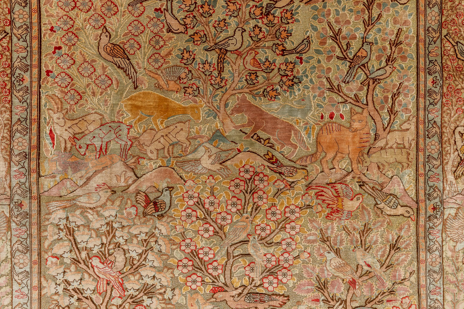 An Oriental hand-made carpet, decorated with fauna and flora. Hereke. (D:144 x W:108 cm)