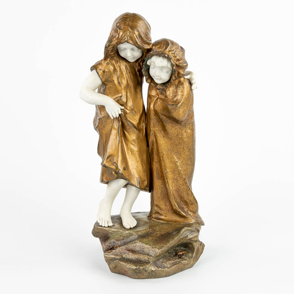 A statue of 2 children with a lobster and crab, made of spelter and bisque porcelain. (H:37,5cm)