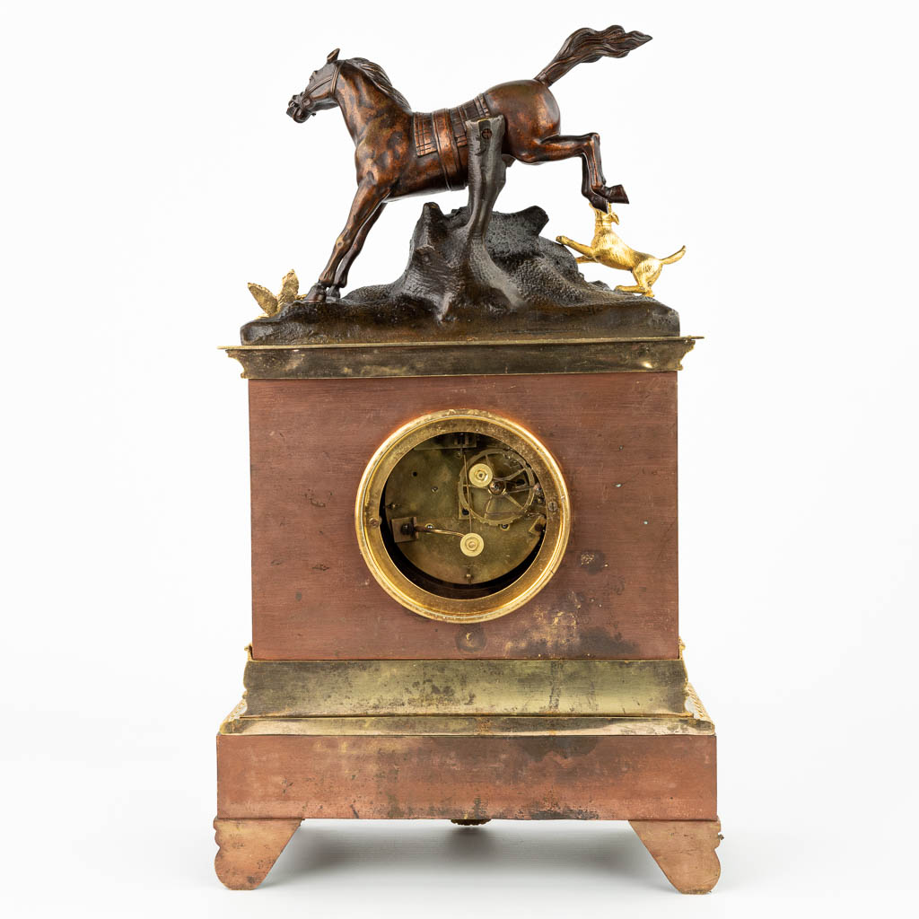 A mantle clock made of bronze and decorated with a horse and dog, empire style. (H:48cm)