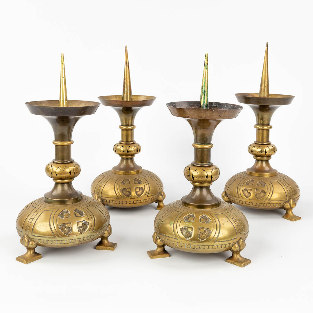A set of 4 church candlesticks made of bronze in a gothic revival style. (H:36 x D:20 cm)