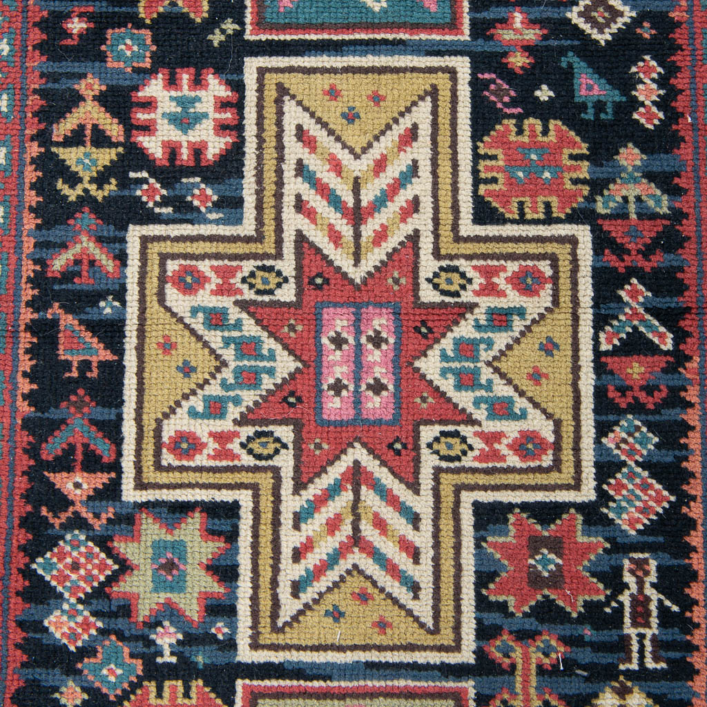 An Oriental hand-made carpet. (219 x 95 cm)