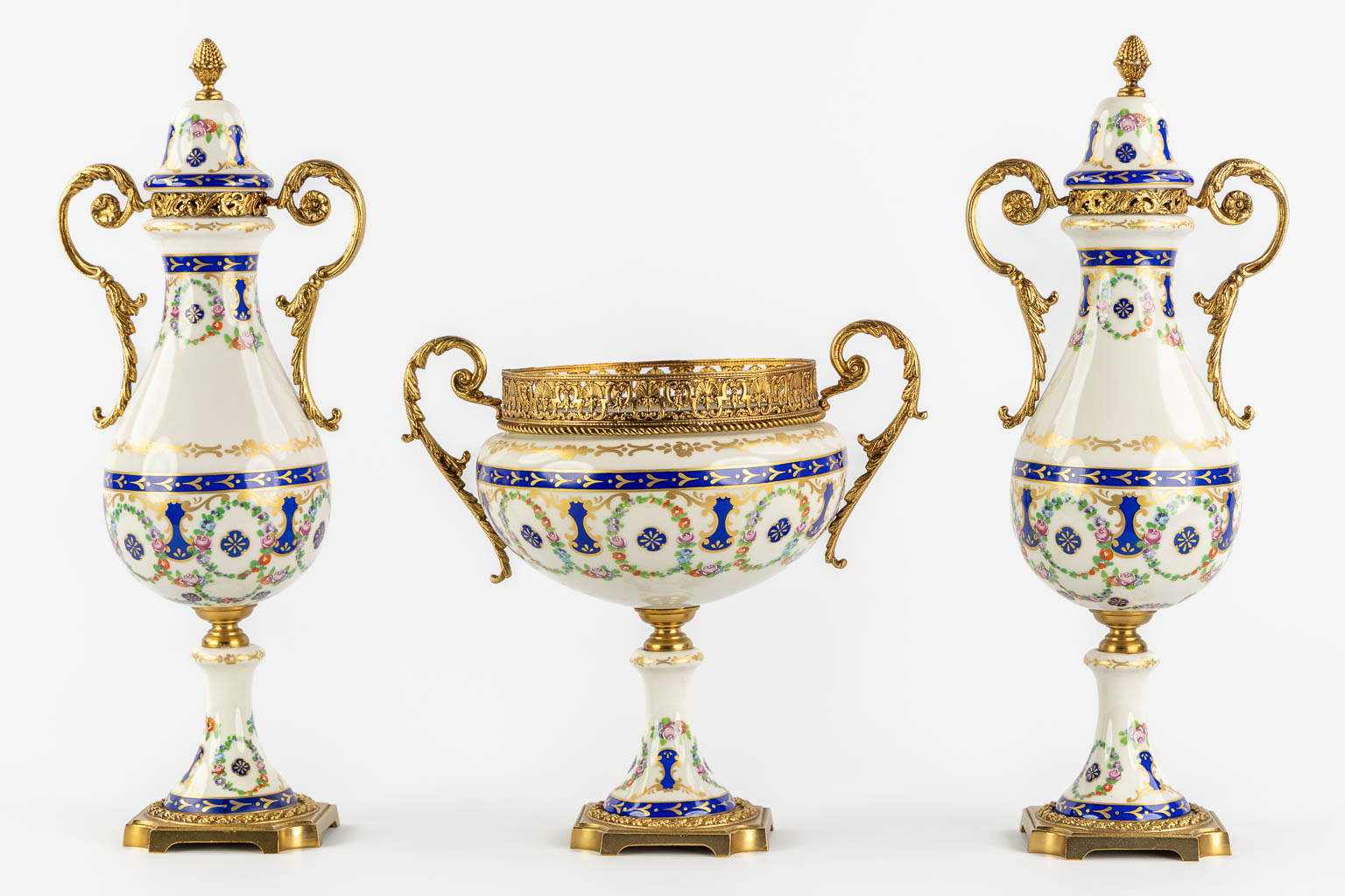 A.C.F. a three-piece mantle garniture, glazed ceramics mounted with bronze. (H:41 cm)