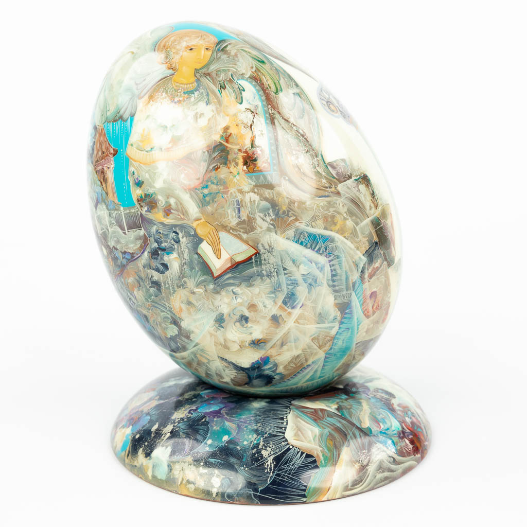 A hand-painted egg on a stand and made of Wood. Marked Stiva Goriachij, made in Russia. (H:17cm)