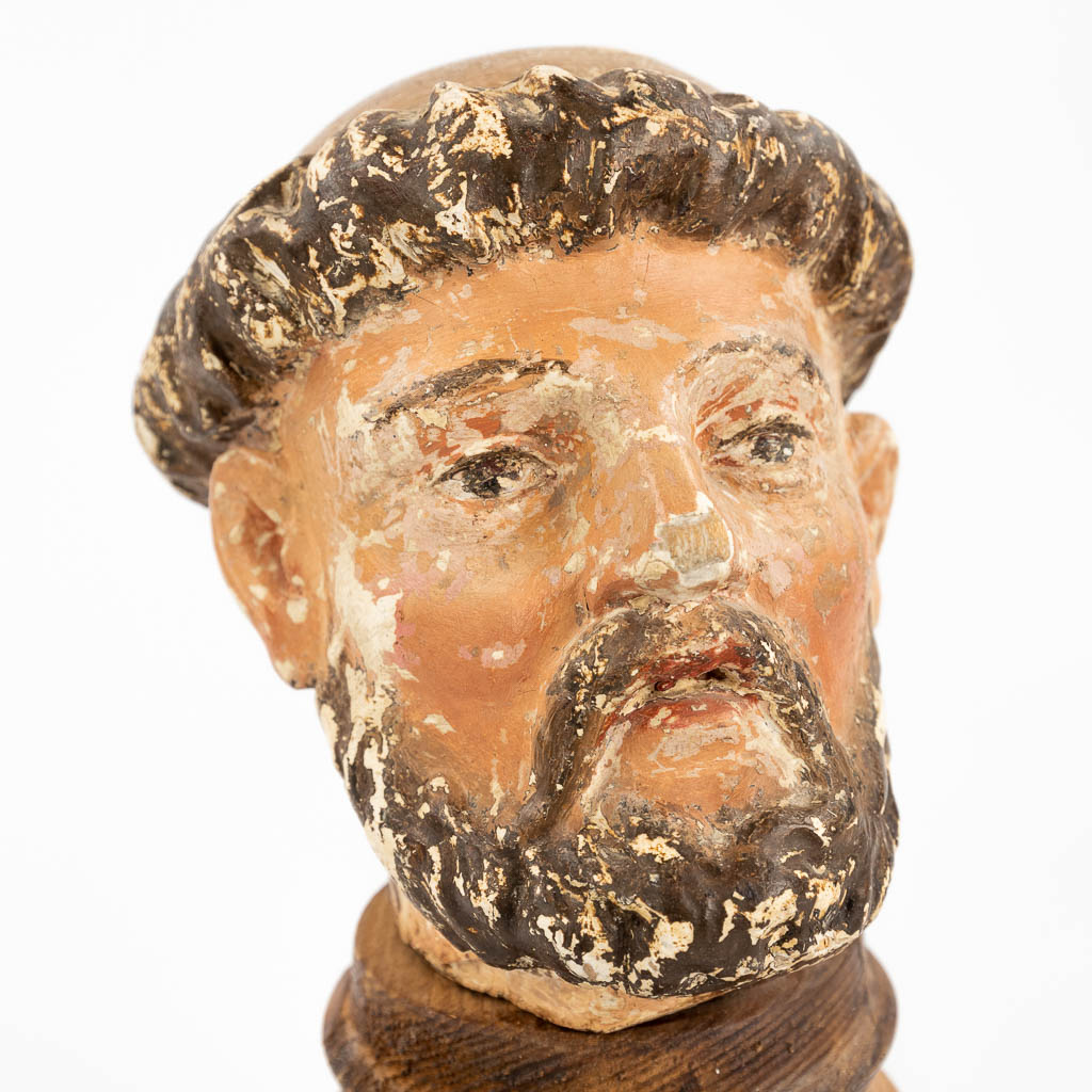 The head of a holy figurine, probably Saint Anthony. Sculptured wood with original polychrome (12,5cm)