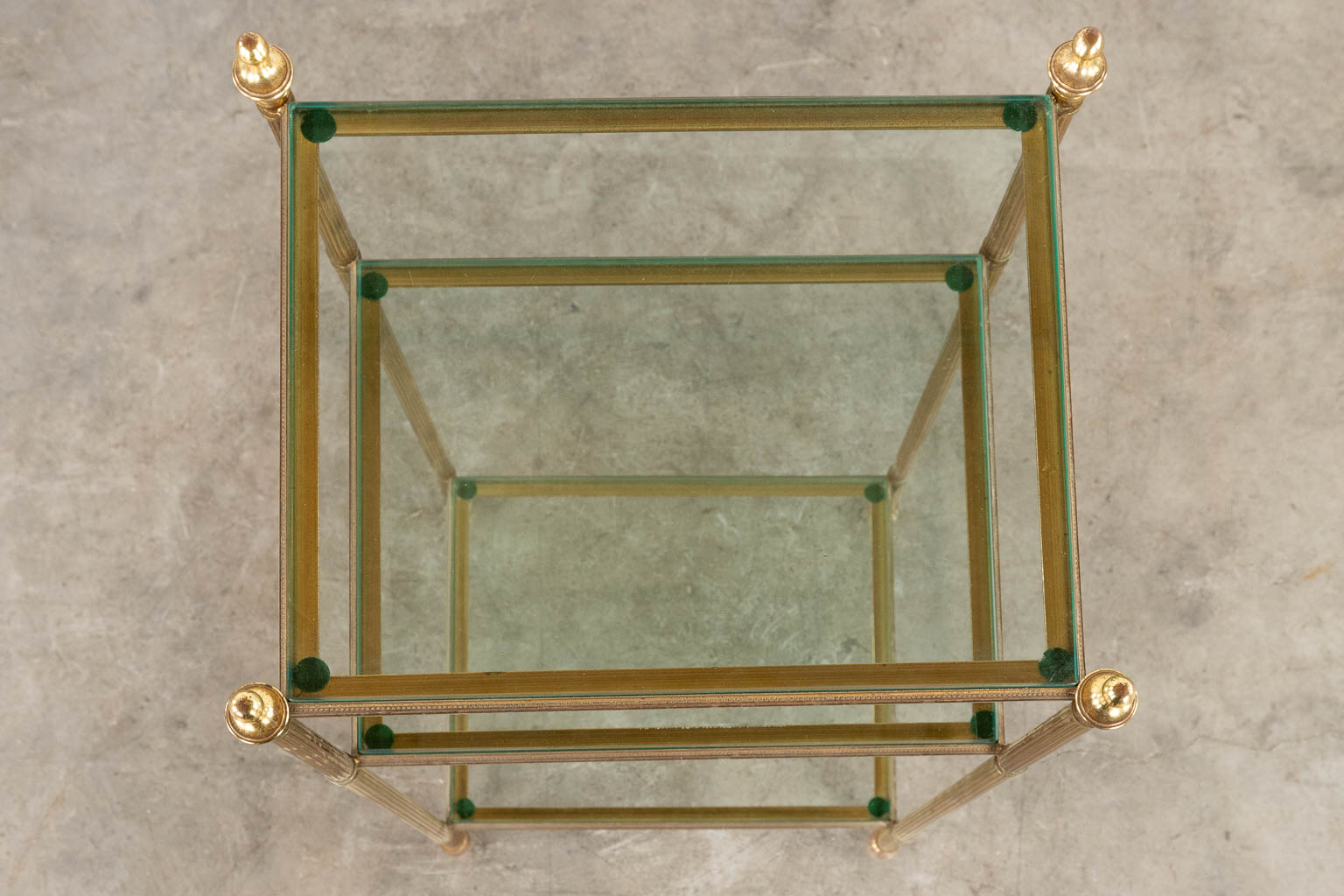 A two-tier side table, brass and glass in the style of Maison Jansen. (D:32 x W:40 x H:70 cm)