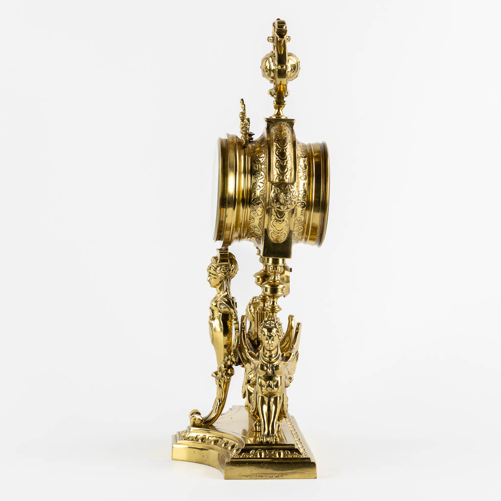 A mantle clock, polished bronze, decorated with Mythological Figures. Circa 1880. (L:15 x W:26 x H:45 cm)