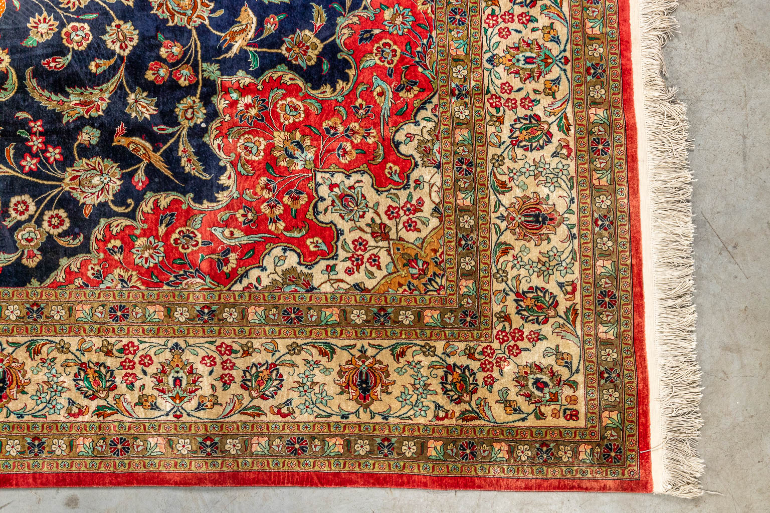 An Oriental hand-made carpet made of silk, decorated with birds and flowers. Keshan. (200 x 310 cm)