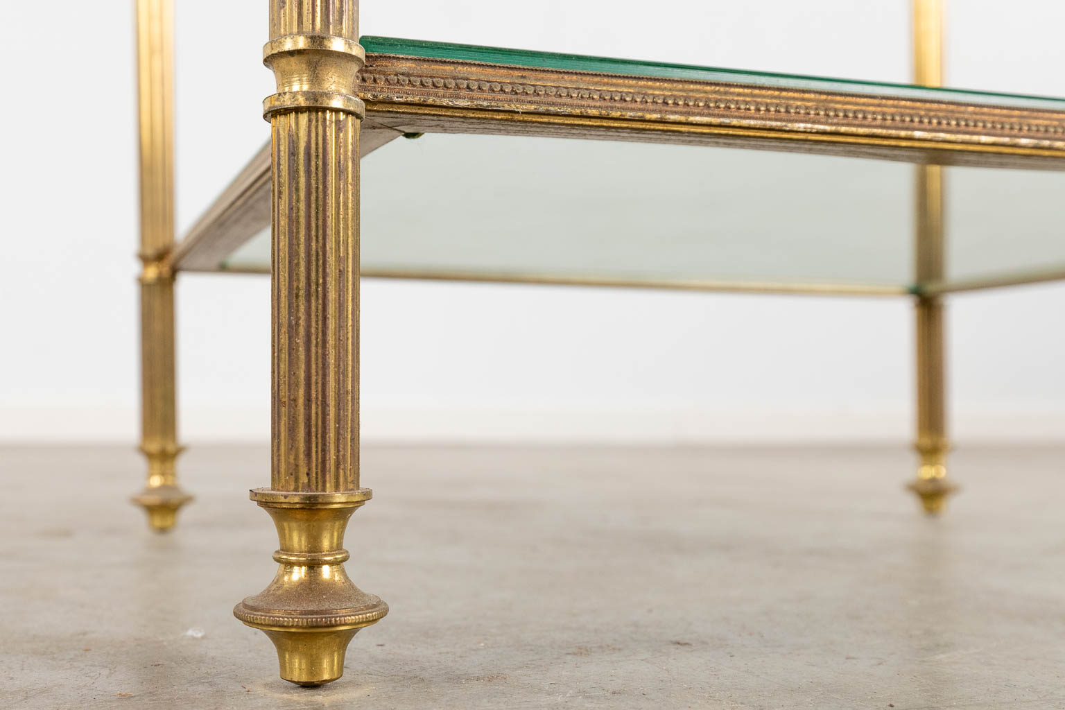 A two-tier side table, brass and glass in the style of Maison Jansen. (D:32 x W:40 x H:70 cm)