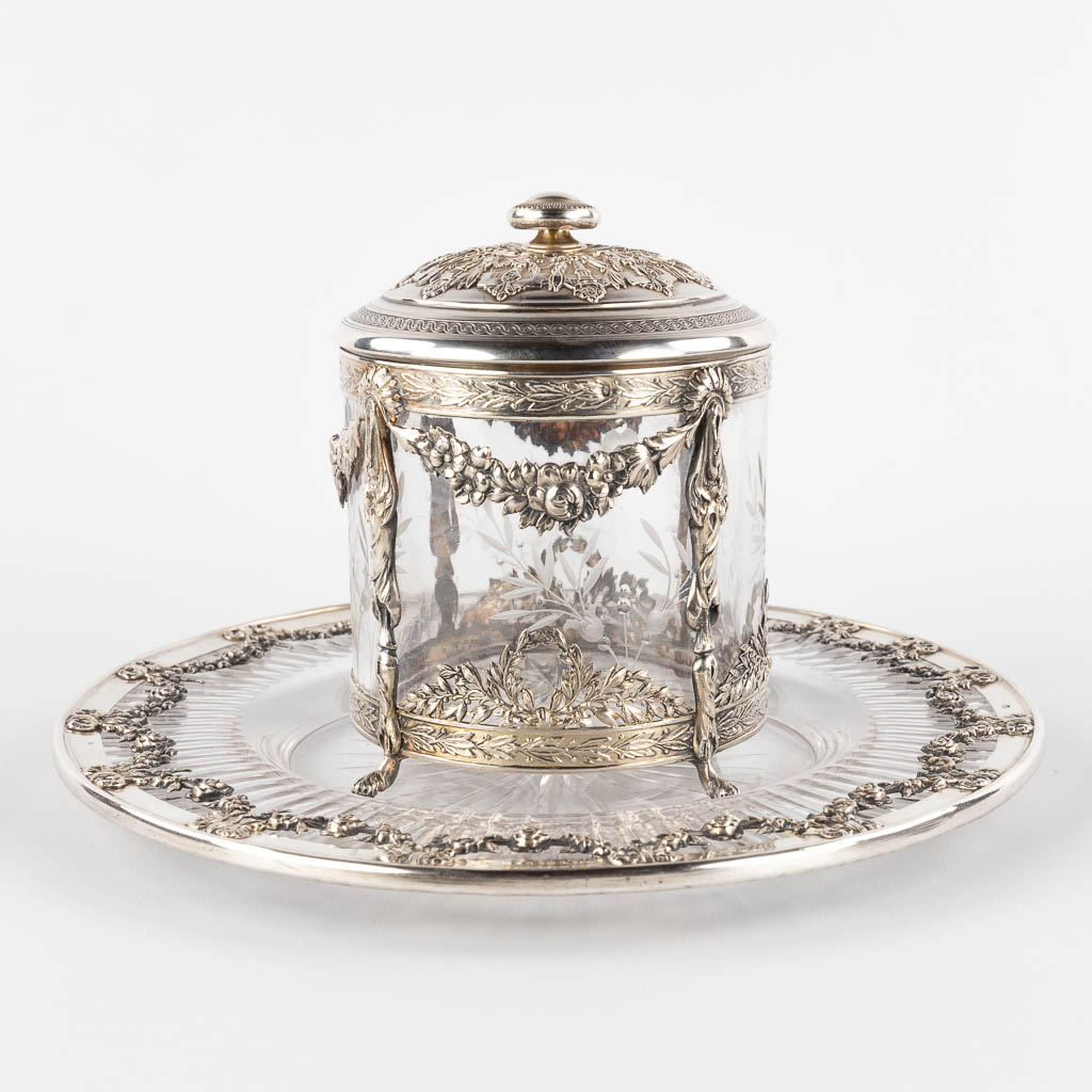 A small storage jar, glass mounted with silver, decorated with garlands. France. (H:13 x D:11,5 cm)