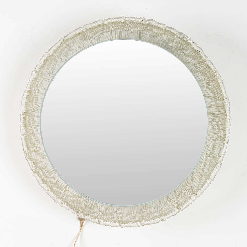 A round mirror, acrylic and glass and made by Deknudt. 