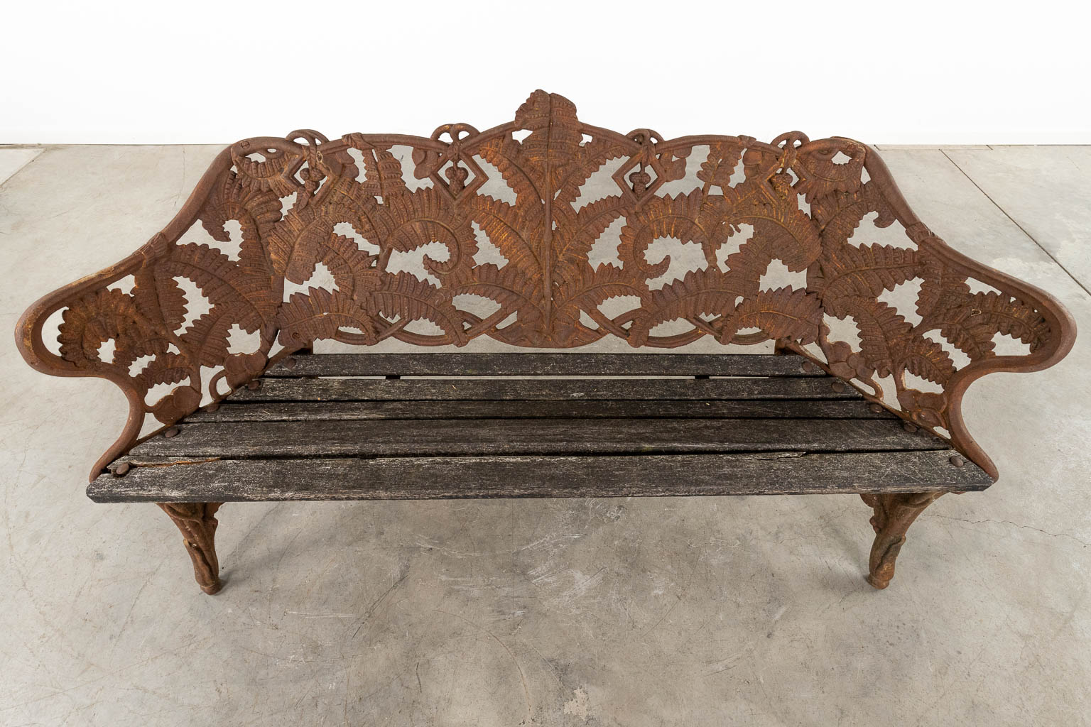 A cast-iron garden bench, decorated with fern leaves. 20th C. (D:53 x W:166 x H:88 cm)