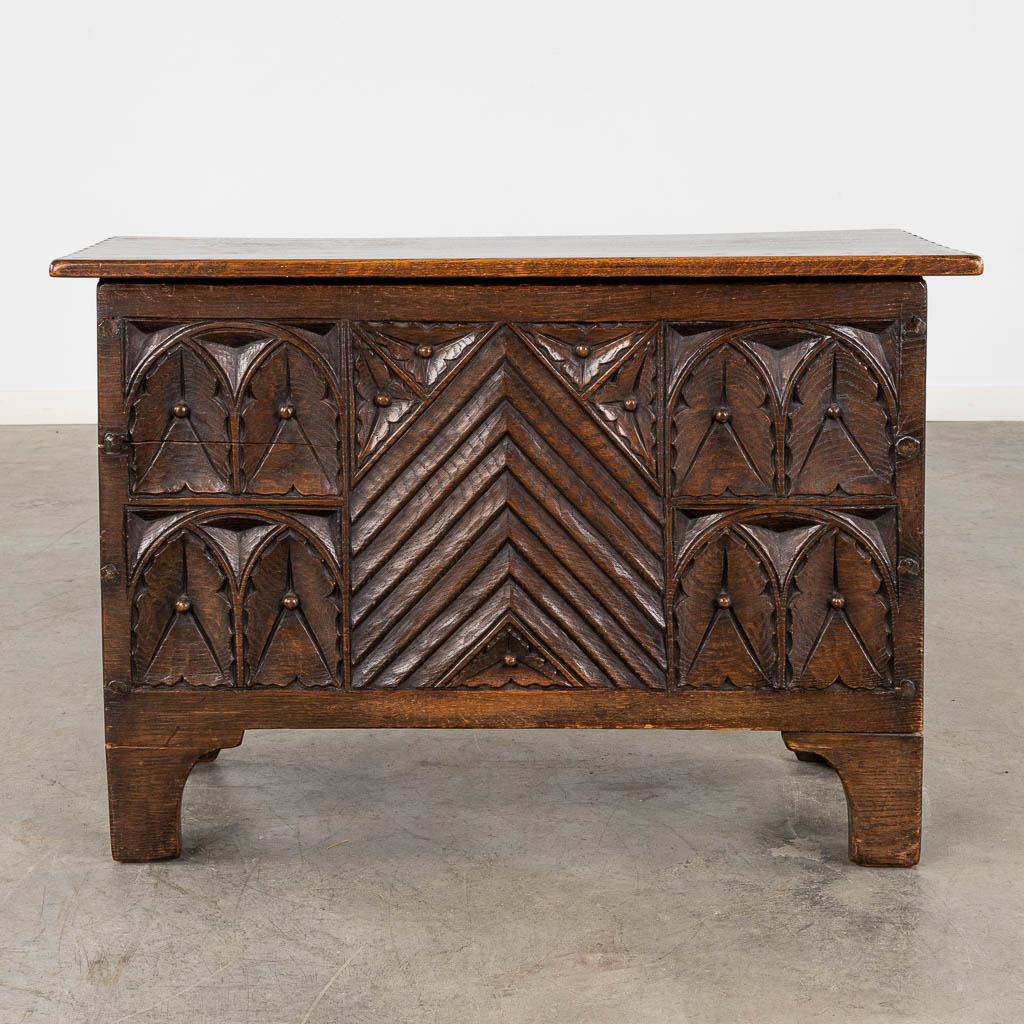 A chest, sculptured panels in a Gothic-revival inspired style. 20th C. (D:35 x W:82 x H:55 cm)