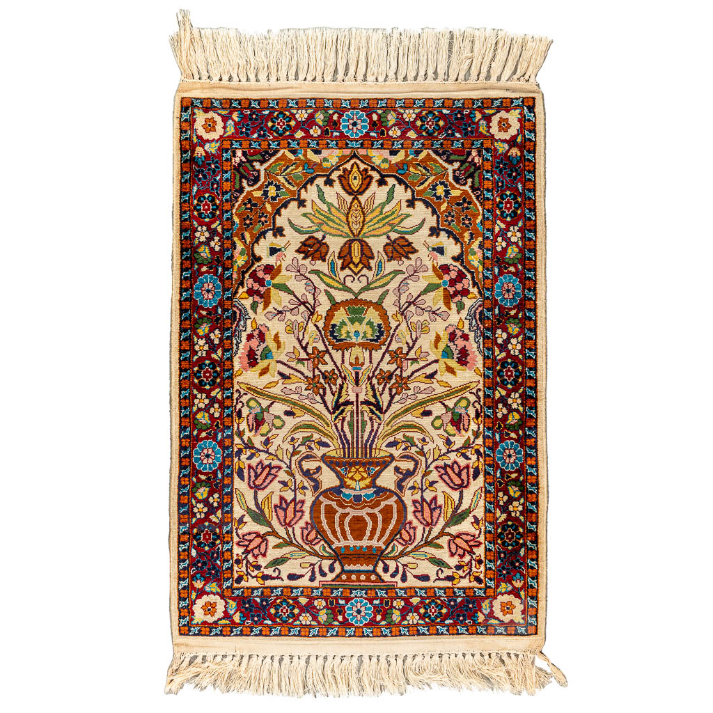 An oriental hand-made carpet made of Kashmir and wool. (90 x 61 cm)