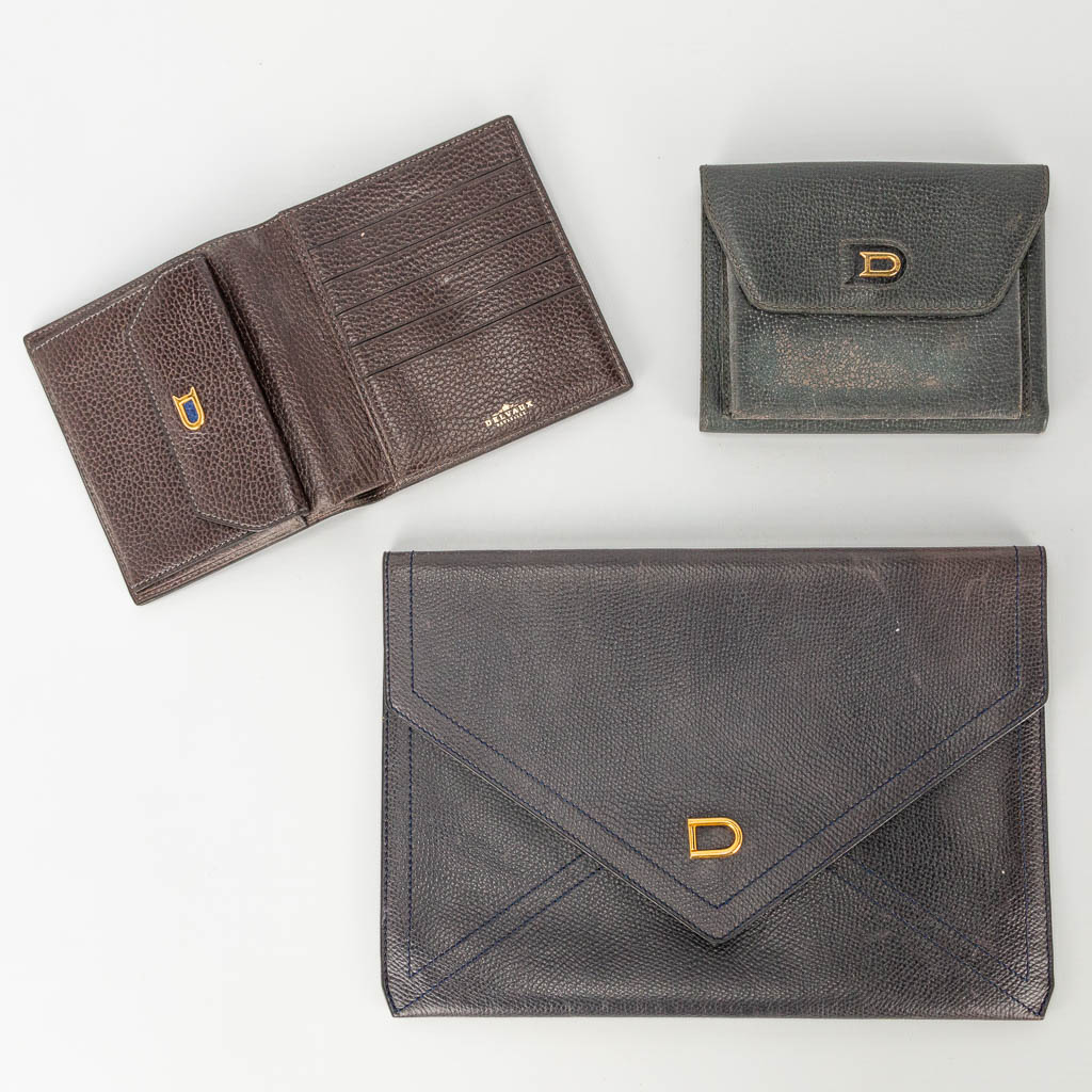 A collection of 2 wallets and a bifold made of leather and marked Delvaux. 