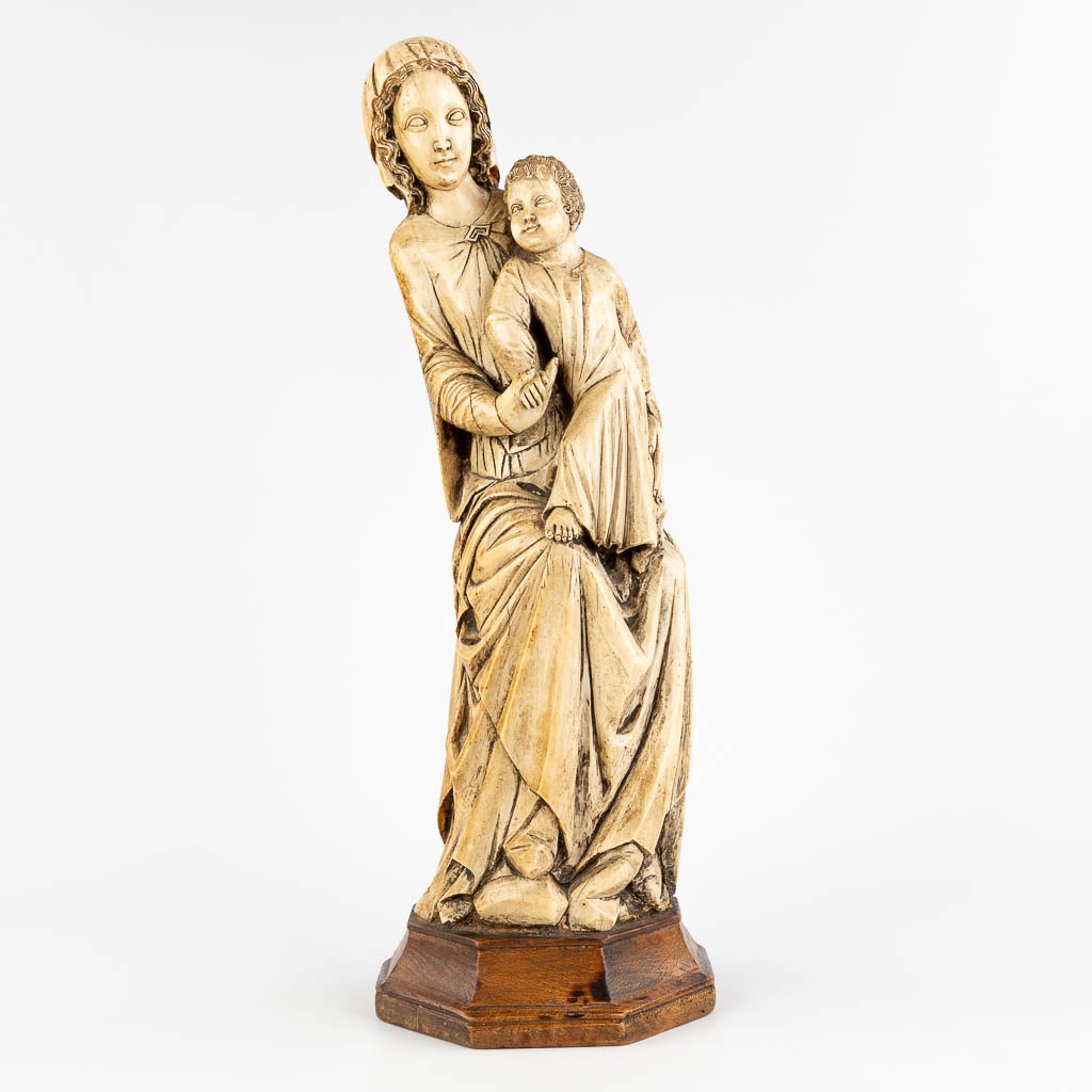 A 'Madonna with Child', sculptured Ivory in gothic revival style, 19th C. (D:18 x W:18 x H:54 cm)