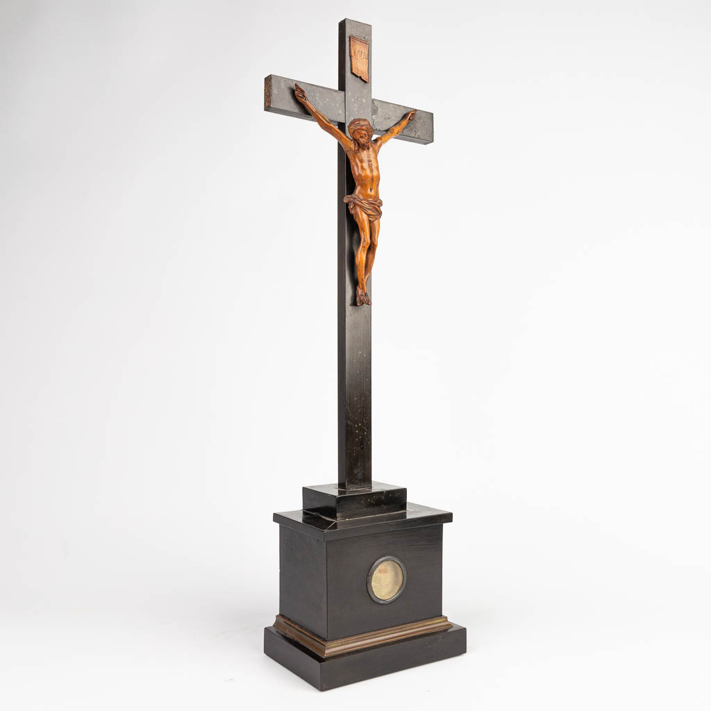 A sculptured Corpus Christi made of palm wood on an ebonised crucifix with a relic from 'Francis Xavier'. (H:51cm)
