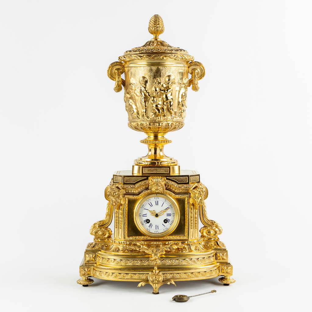 A gilt bronze mantle clock, richly decorated with putti, ram's heads and garlands in Louis XV style. 19th C. (L:27 x W:35 x H:60