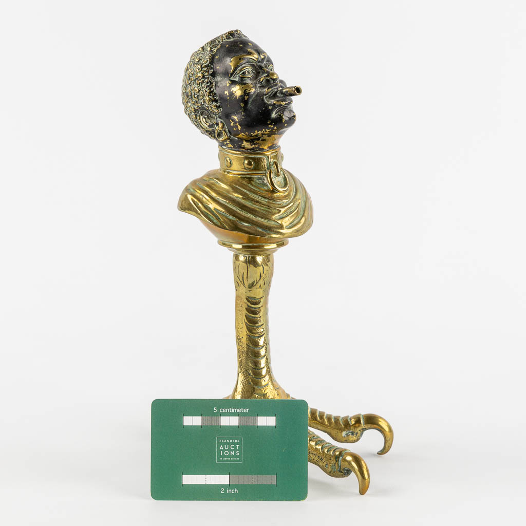 An antique Cigarette or Cigar lighter, polished bronze in the shape of a Blackamoor. 19th/20th C. (L:16 x W:13 x H:25 cm)