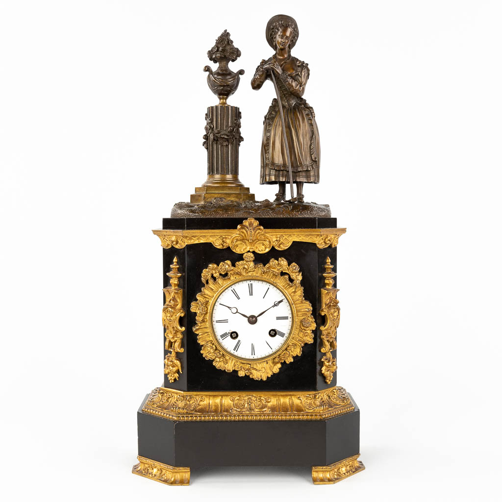 A black marble and bronze mantle clock 