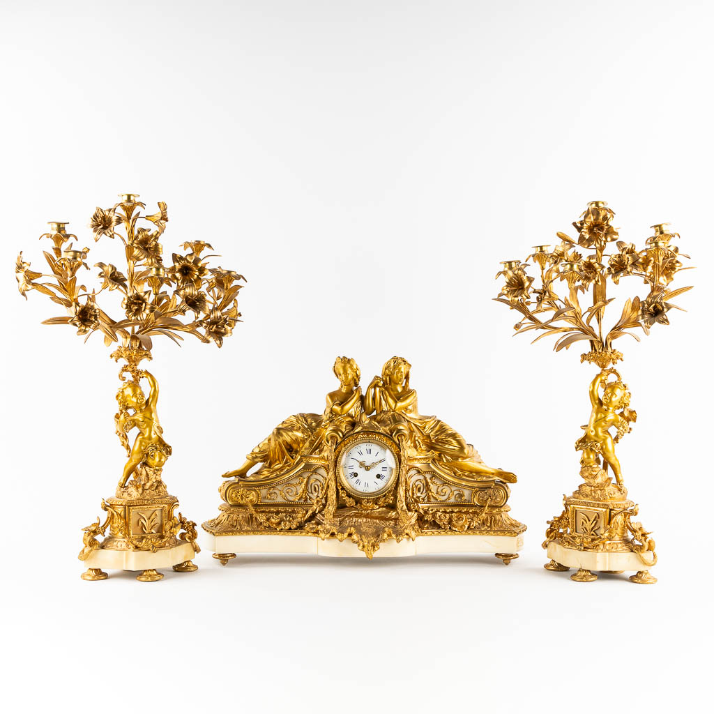 Lot 031 An impressive three-piece mantle garniture clock and candelabra, gilt bronze and marble. 19th C. (L:20 x W:61 x H:38 cm)