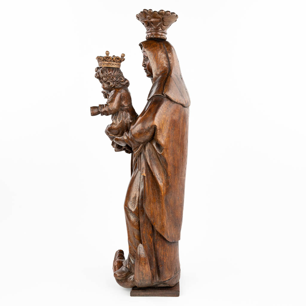 A large statue of Madonna with a child, trampling the serpent on a crescent, made of sculptured oak. (H:83cm)