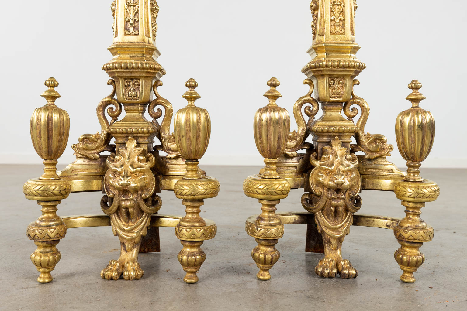 A pair of fireplace bucks, gilt bronze decorated with lion
