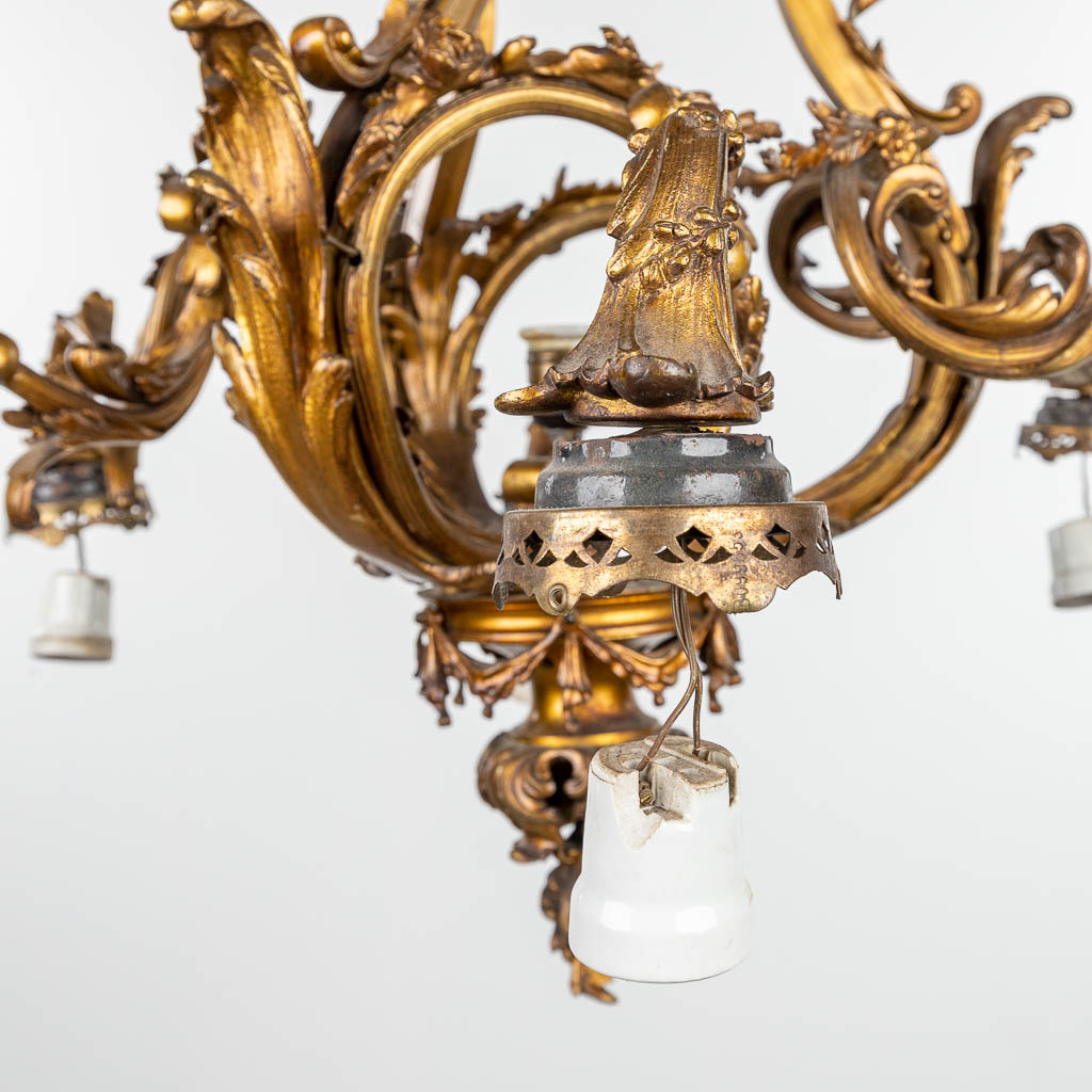 A large chandelier made of bronze in Louis XV style and finished with glass shades. (H:103cm)