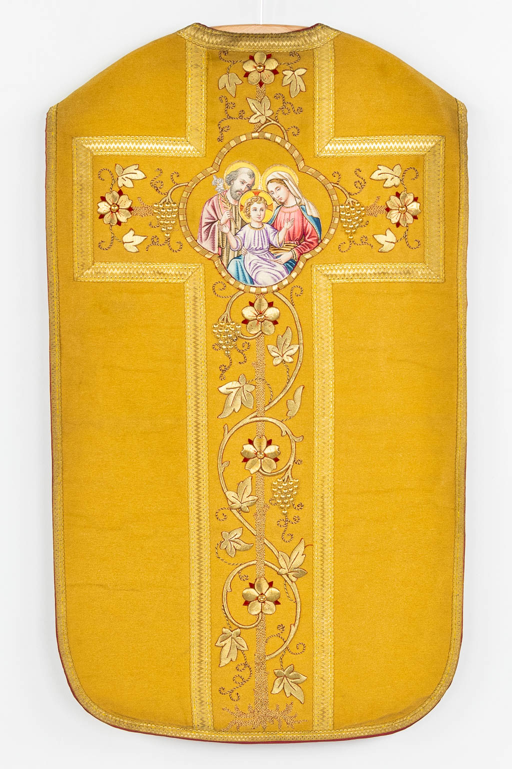 A Cope and two Roman Chasubles, thick gold thread embroideries and images of The holy family.