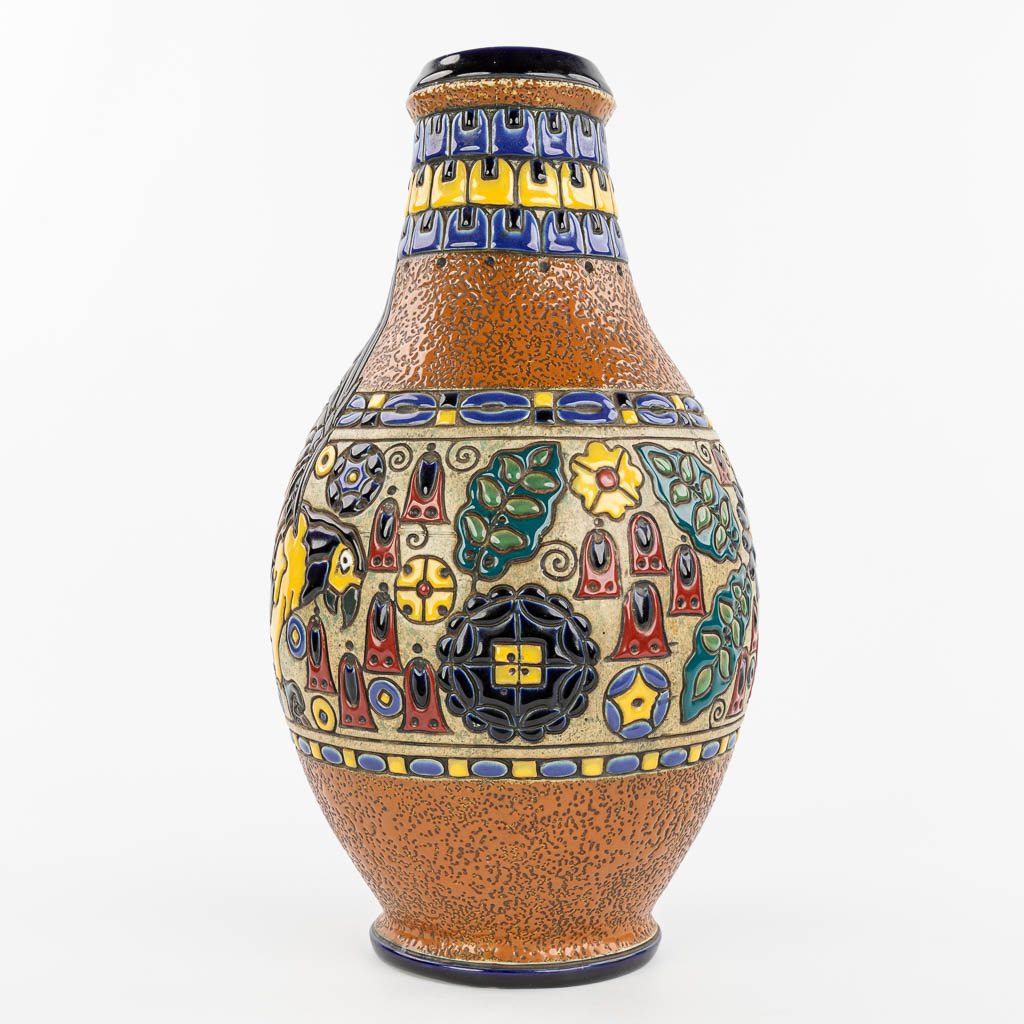 A vase made of glazed faience and decorated with an ara parrot, marked Amphora Teplitz. (H:45cm)