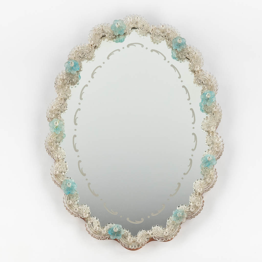 A small Venetian glass wall-mounted mirror, decorated with blue flowers. (W:45 x H:60 cm)