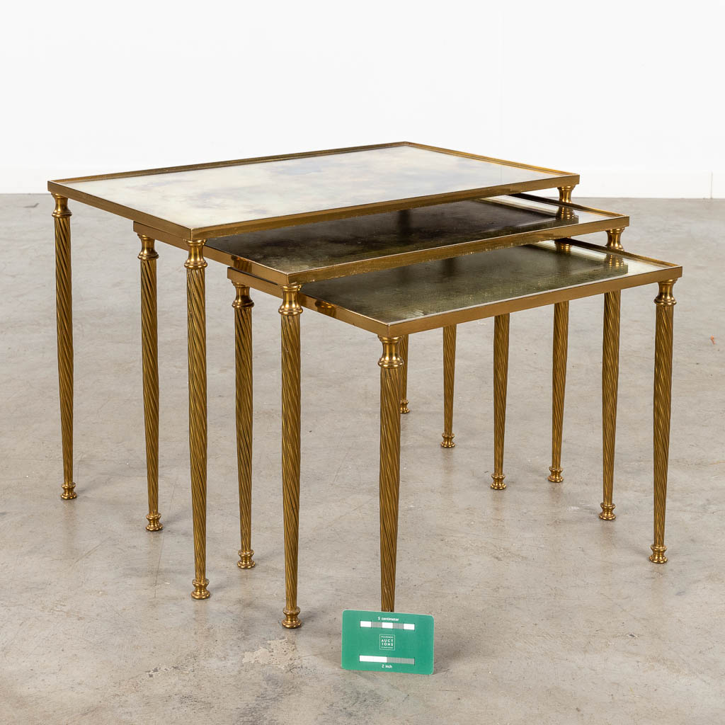 A set of 3 matching side tables with fumé glass, style Maison Jansen. (L: 34 x W: 54 x H: 39 cm)
