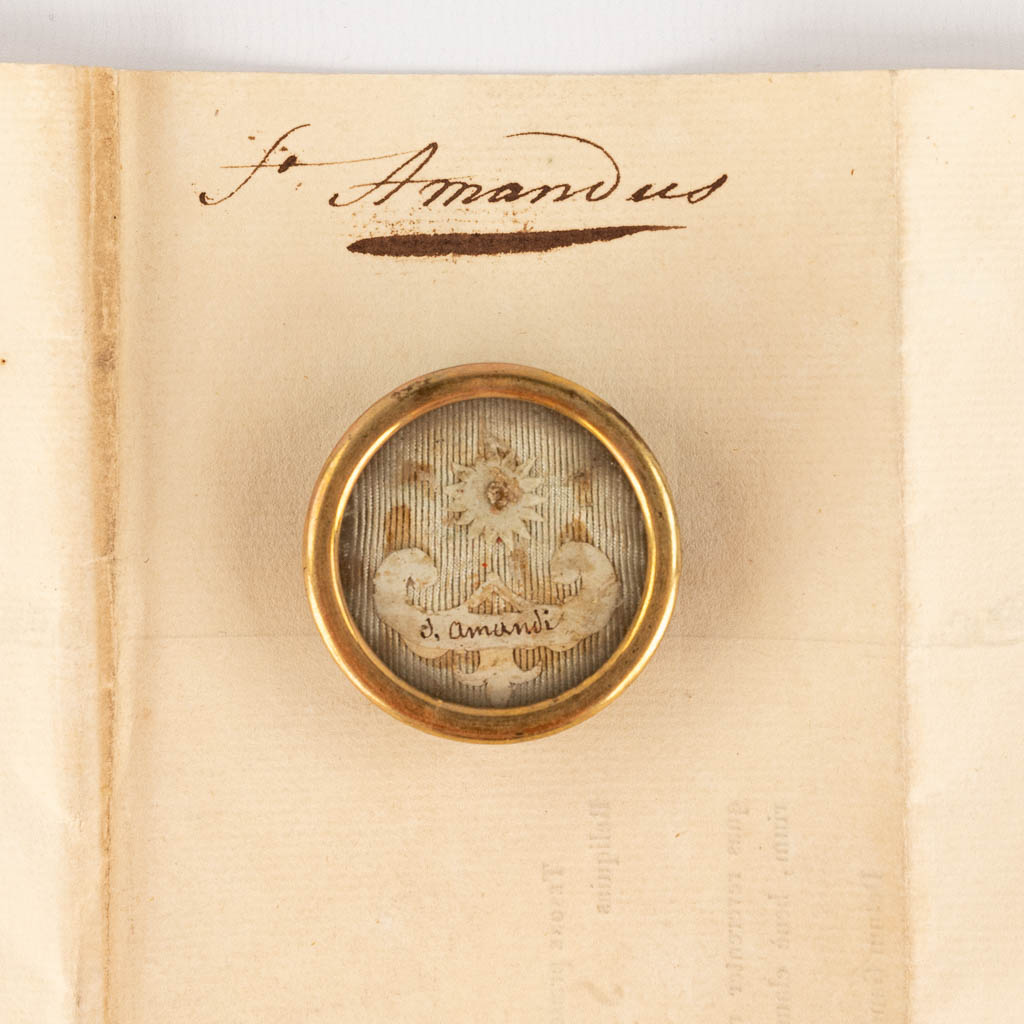 A sealed Theca with a relic and document: Sancti Amandi (H:1,1 x D:3,8 cm)