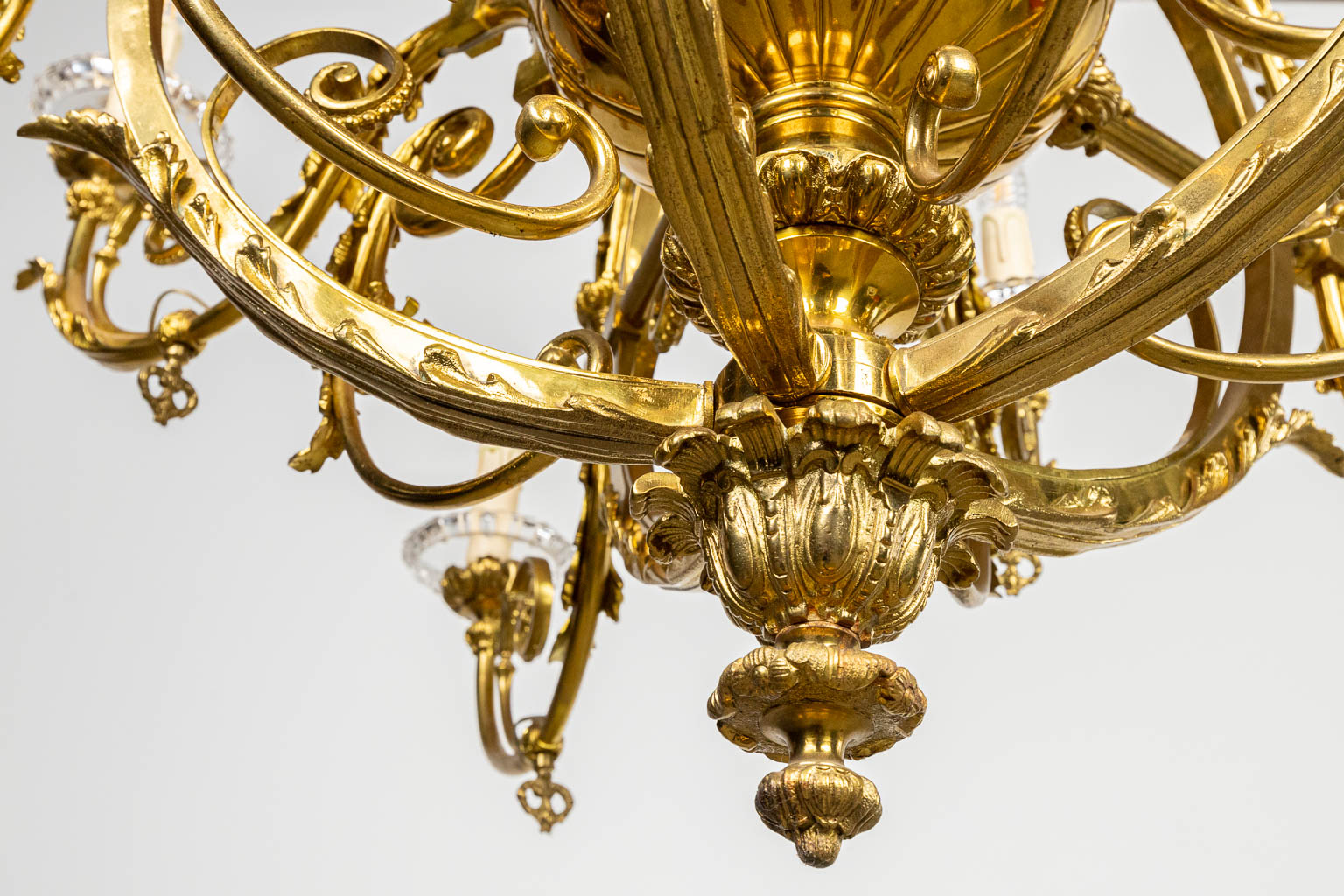 An antique and electrified gas chandelier, made of bronze