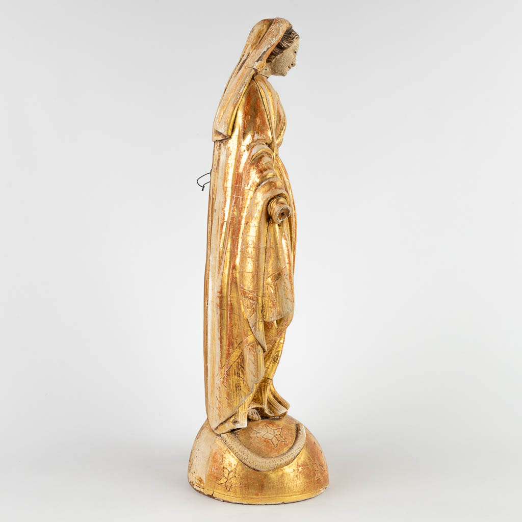 An antique gilt wood figurine of Madonna standing on the crescent moon and serpent. 19th C. (D:15 x W:23 x H:49 cm)