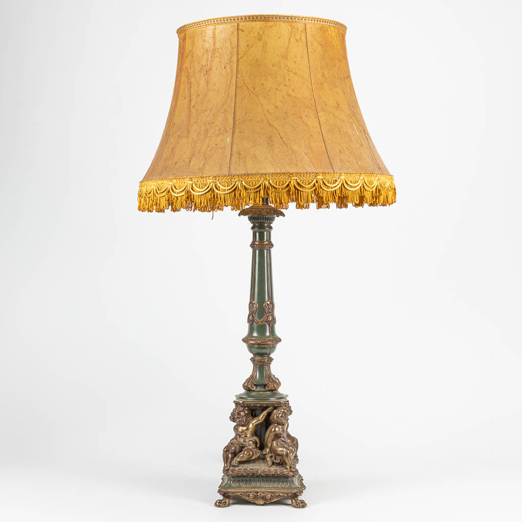 A table lamp made of bronze with putti. The second half of the 20th century. 